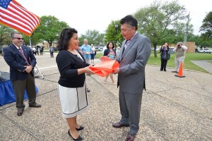 Brooks Chairman Manuel Villa presenting the Hangar 9 windsock to Councilwoman Rebecca Viagran.
